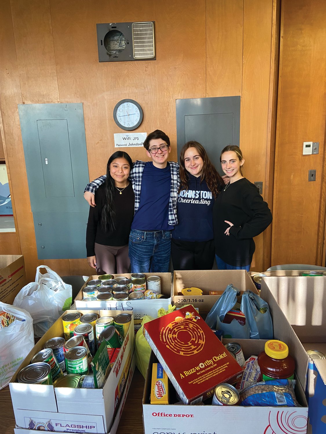 Members of SADD, President Charlie Curci, Vice President Rachel Ixcotoyac, Senior Class President Charlene Hohlmaier, and Senior Class Student Council Representative Janet Clements pose with the food collected for the food drive.